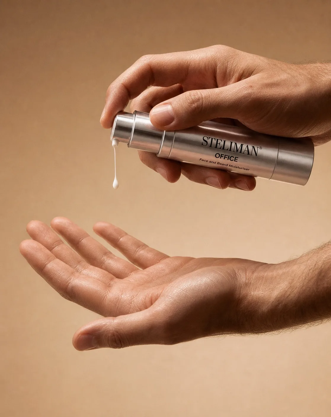 Hands dispensing a silver bottle of Steliman Office moisturizer onto the other palm; label reads 'STELIMAN OFFICE Face and Beard Moisturiser'